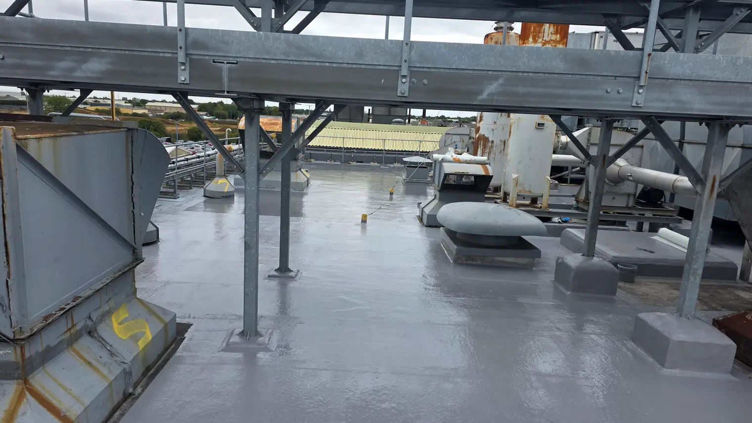 Finished polyurethane liquid roof around rooftop plant on an industrial building